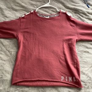 PINK. Crew neck, cut out sleeves. Maroon ish color. Xs